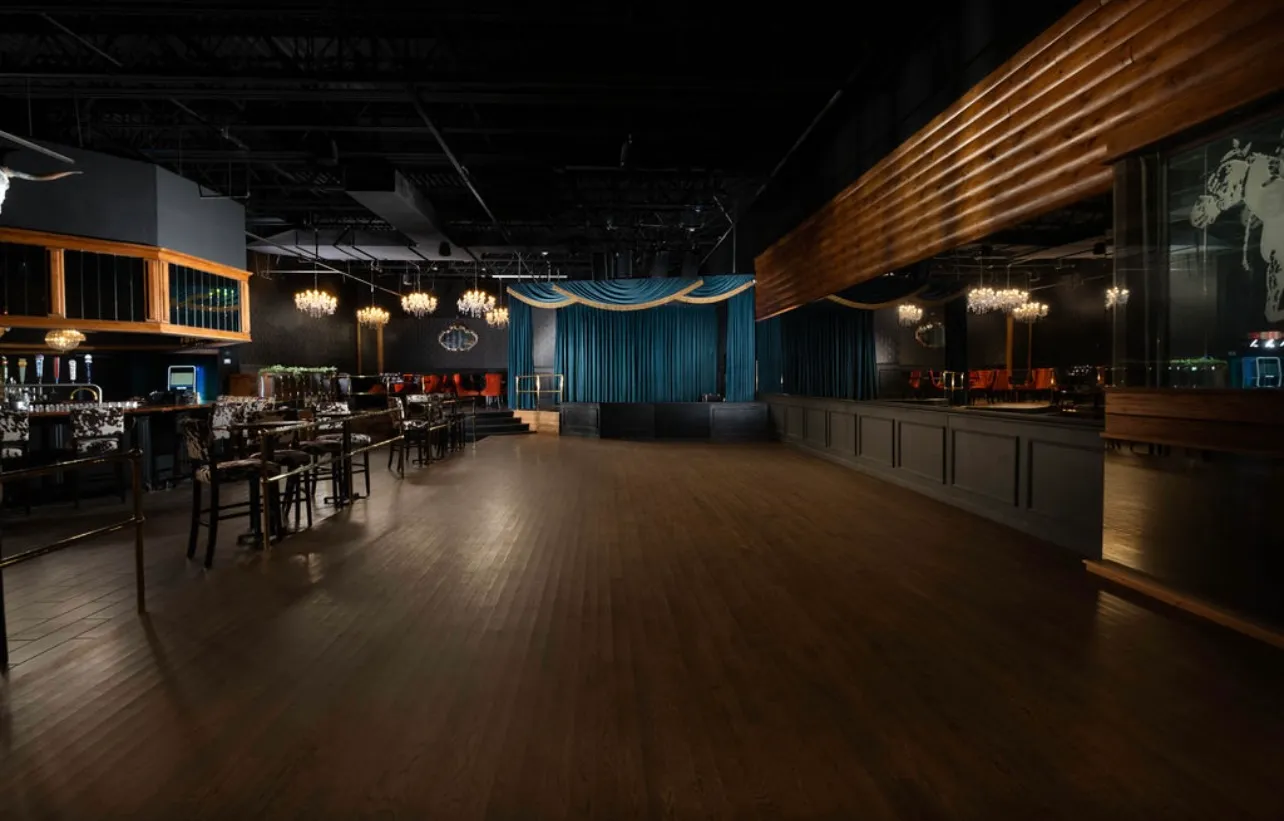 The teal-curtained stage and dance floor
