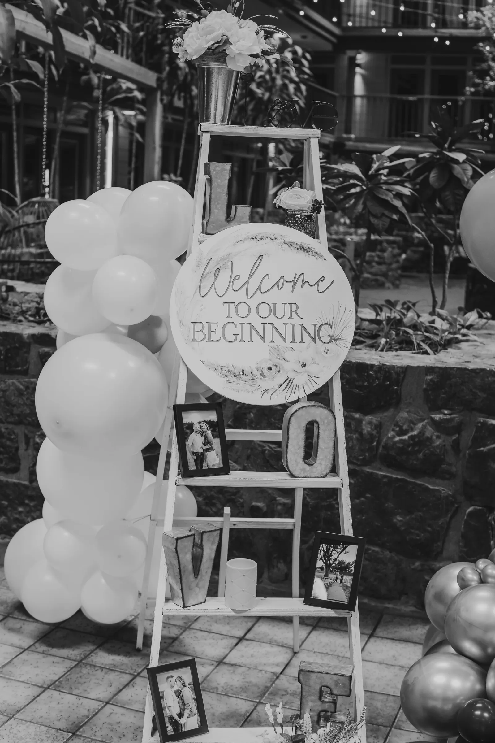 A wedding welcome display on a ladder in the atrium