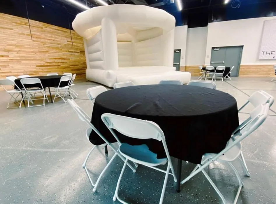 A white bounce house set up indoors