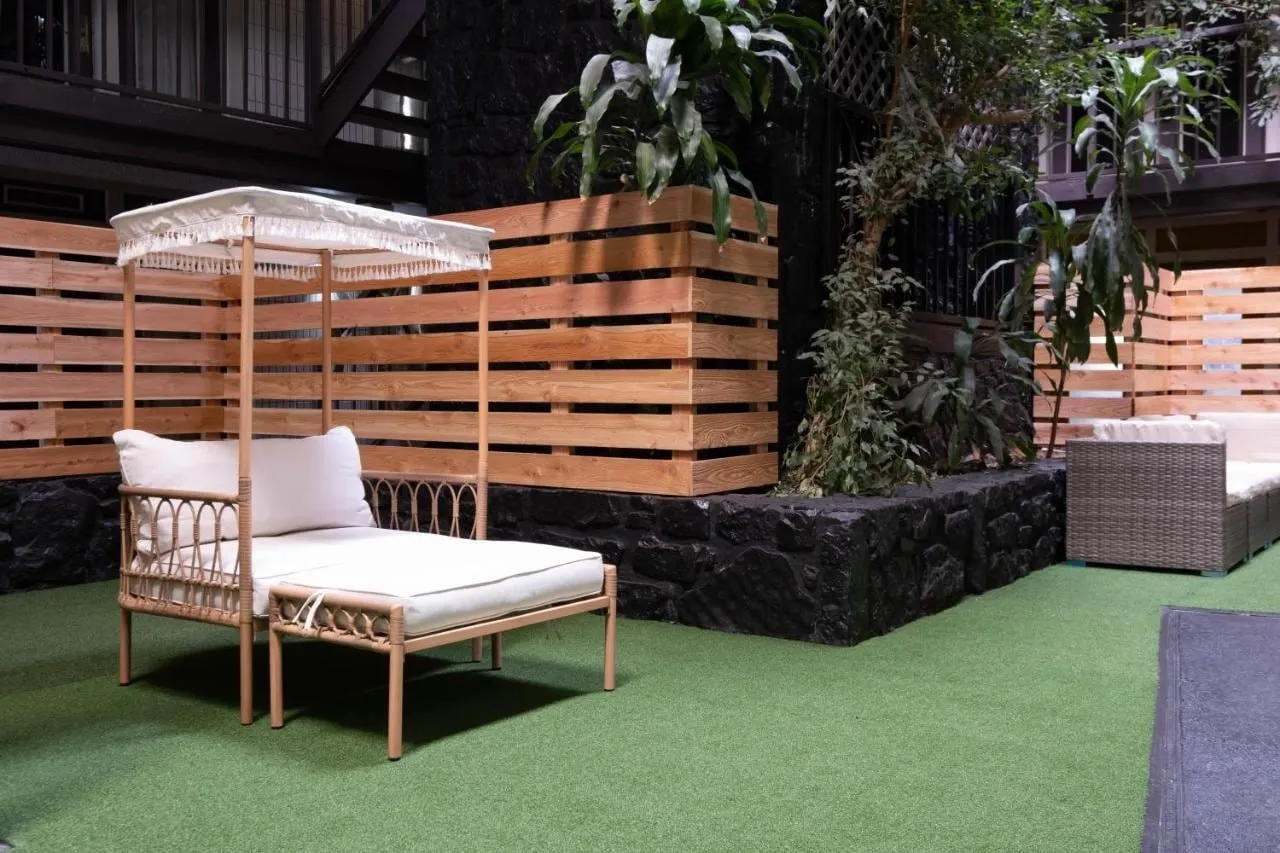 A cabana under the pergola on the atrium turf
