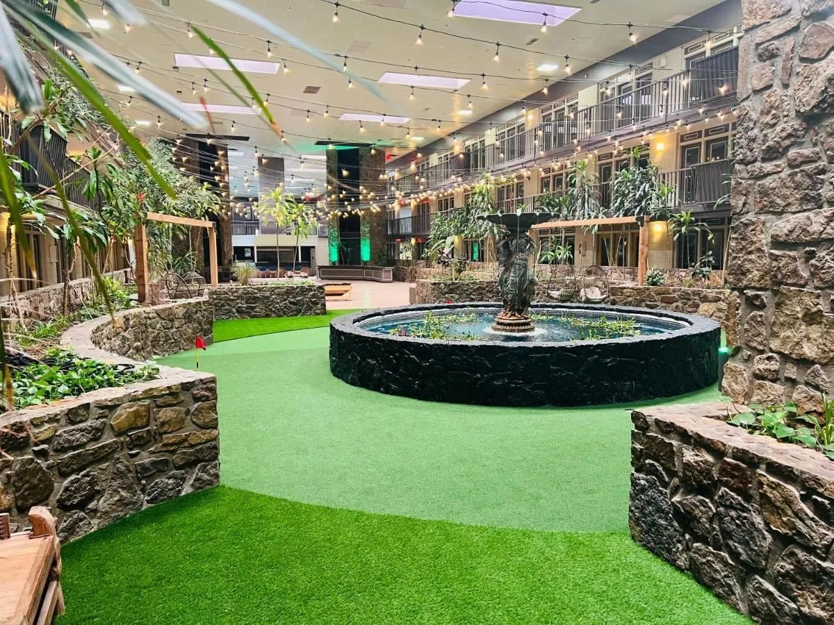 The atrium fountain and putting green under string lights