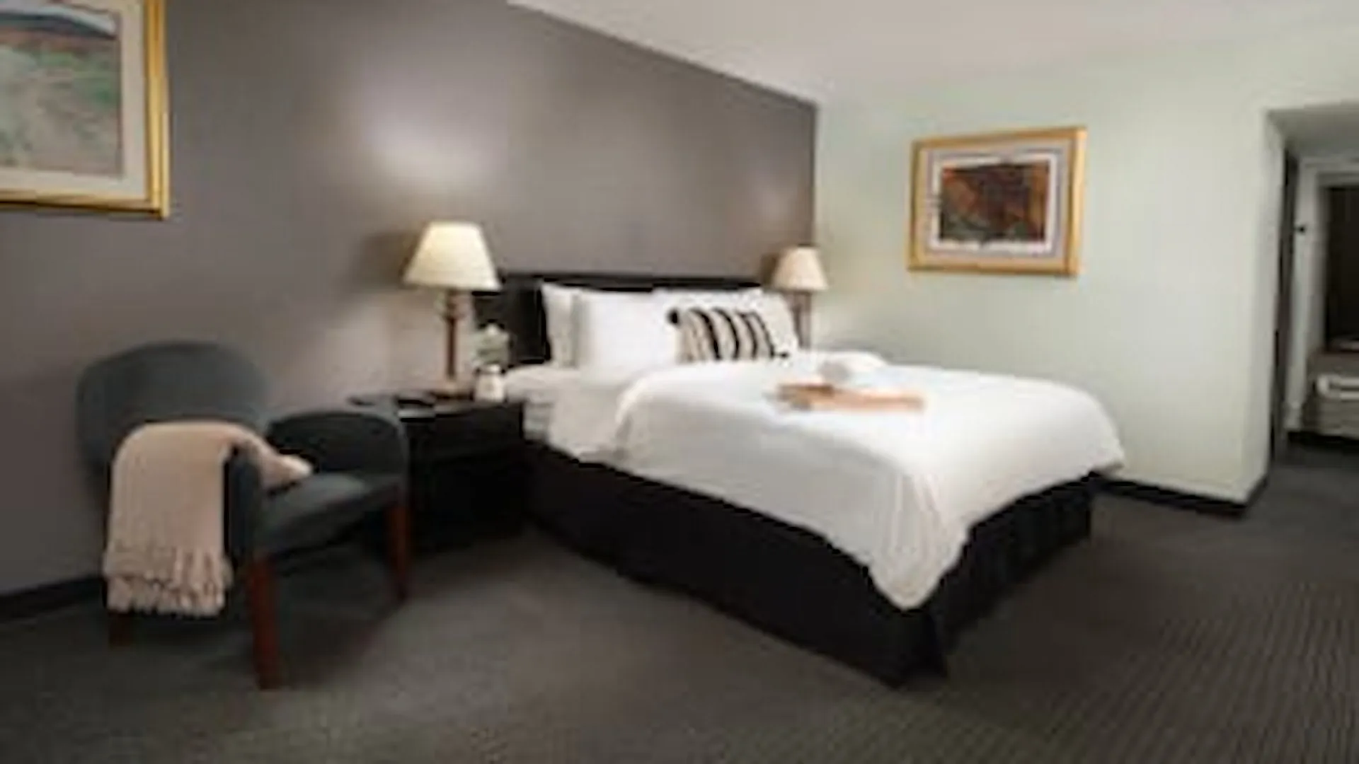 Basic king room with armchair and warm lamp light