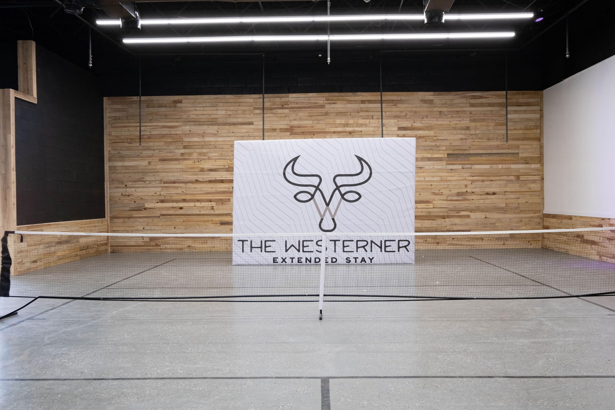 The indoor pickleball court with The Westerner sign